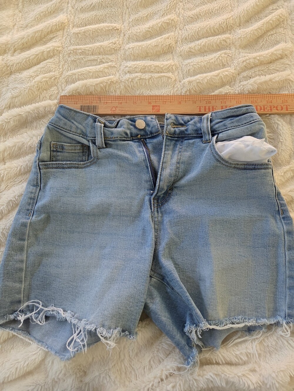Oat Size 2 light-wash denim shorts with a raw, frayed hem from